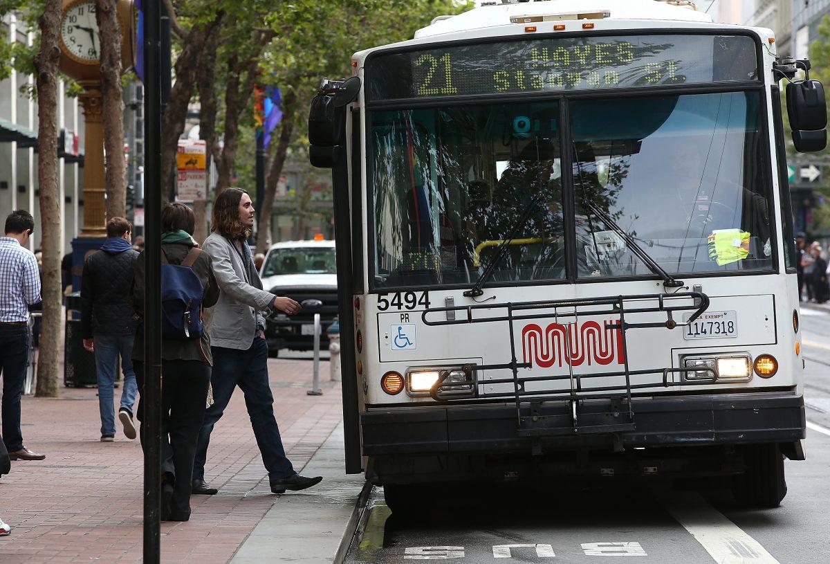 A passenger boards a San Francisco Municipal Transit Agency bus in San Francisco, Calif., on June 3, 2014. (Justin Sullivan/Getty Images)