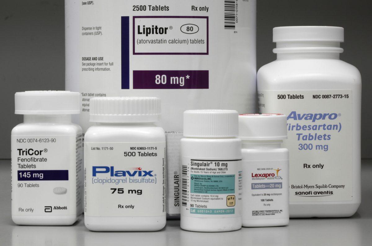 In this file photo, bottles of prescription drugs such as Lipitor, TriCor, Plavix, Singulair, Lexapro, and Avapro are displayed at Medco Health Solutions Inc., in Willingboro Township, N.J., June 14, 2011. (Matt Rourke/AP Photo)