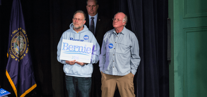 Jerry Greenfield (L) and Ben Cohen listen to Democratic presidential candidate Sen. Bernie Sanders at a rally after endorsing him in Exeter, N.H., on Feb. 5, 2016. (Andrew Burton/Getty Images)
