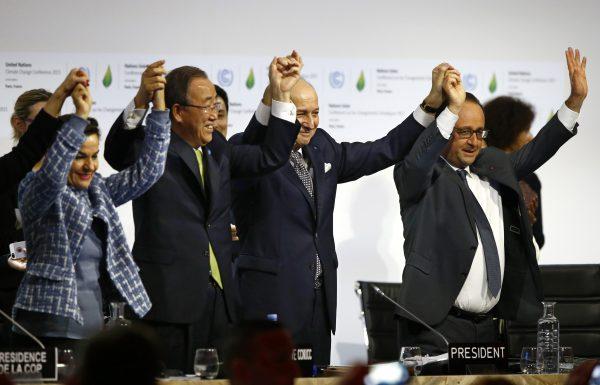 French President Francois Hollande (R), French Foreign Minister and COP21 President Laurent Fabius (2nd R), U.N. Climate Chief Christiana Figueres (L), and U.N. Secretary General Ban Ki-moon celebrate after the final conference at the COP21 in Le Bourget, Paris. (AP Photo/Francois Mori)