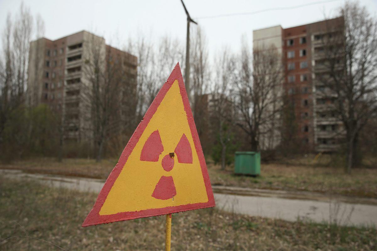 A sign warns of radiation contamination near former apartment buildings in Pripyat, near Chernobyl, Ukraine, on April 9, 2016.  (Sean Gallup/Getty Images)