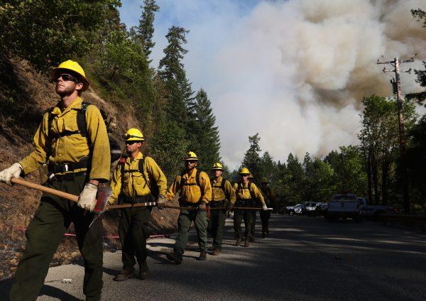 In this July 28, 2015 photo, Department of Forestry firefighters prepare for work at the Cable Crossing Fire near Glide, Ore. (Michael Sullivan/The News-Review via AP)