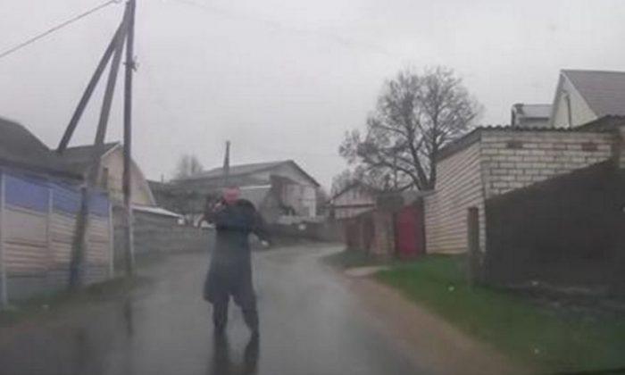 Video: Man Stops Driver, Does the Splits on the Wet Pavement
