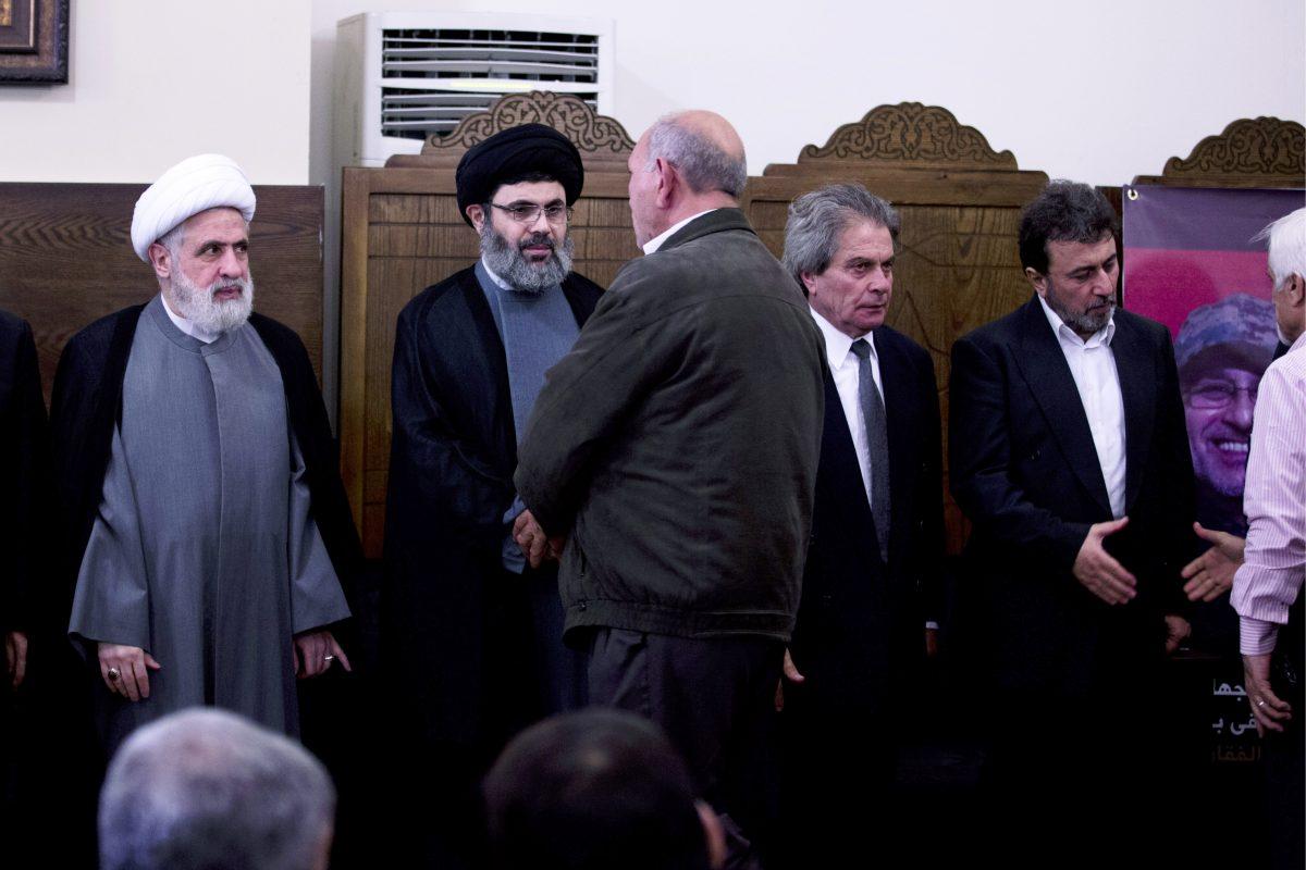 The deputy chief of Hezbollah, Sheik Naim Kassem, left, and Sayyed Hashem Safieddine, in black turban, receiving condolences in Beirut after the 2016 death of Hezbollah's top military commander for Syria. Safieddine's killing in an Israeli air strike was confirmed on Oct. 8, 2024, by Prime Minister Benjamin Netanyahu. (Hassan Ammar/AP Photo)