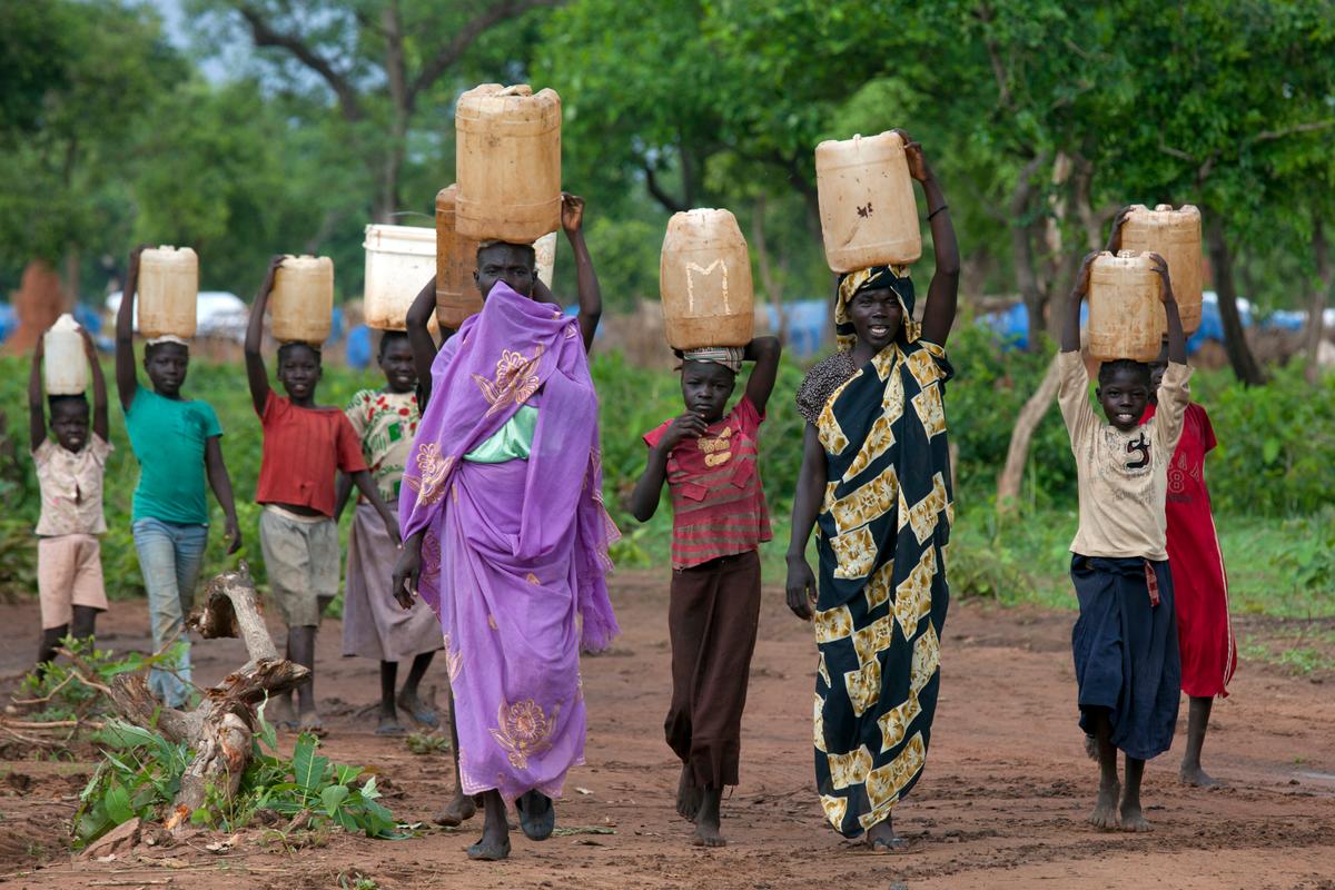Sudanese women and children carry water at the Yida refugee camp along the border with Sudan, in Yida, South Sudan, on June 30, 2012. (Paula Bronstein/Getty Images)