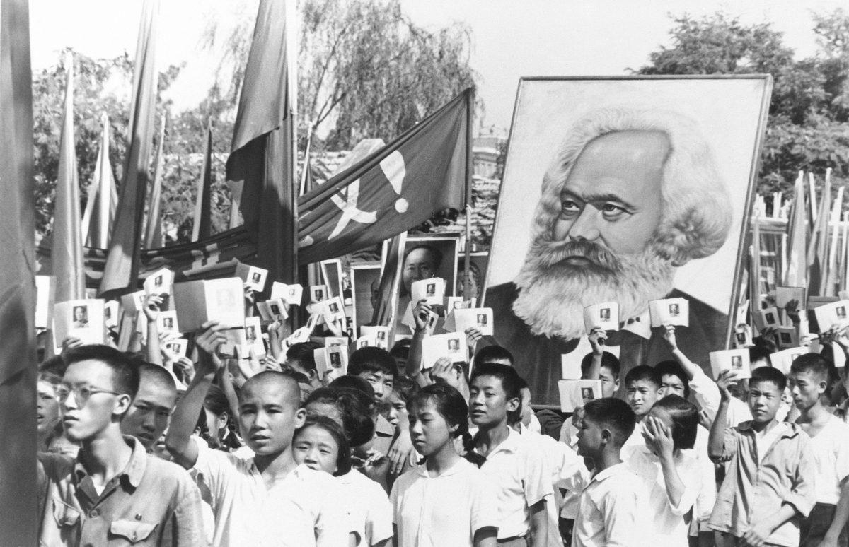 Youths are seen at a rally during the height of the Red Guard upheaval waving copies of the collected writings of Communist Party Chairman Mao Zedong, often referred to as Mao's Little Red Book, and carrying a poster of Karl Marx. (AP Photo)