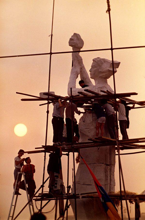 Protesters occupying Beijing's Tiananmen Square work on the statue of the Goddess of Democracy on May 30, 1989. The makeshift statue, modeled after the Statue of Liberty, was destroyed, and hundreds of people killed, when Chinese soldiers overran the square in the early morning hours of June 4, 1989. (Jeff Widener/AP)