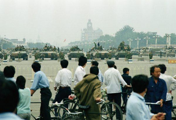 Crowds of Beijing residents watch the military block access to Tiananmen Square in Beijing on June 7, 1989. (Sadayuki Mikami.AP Photo)