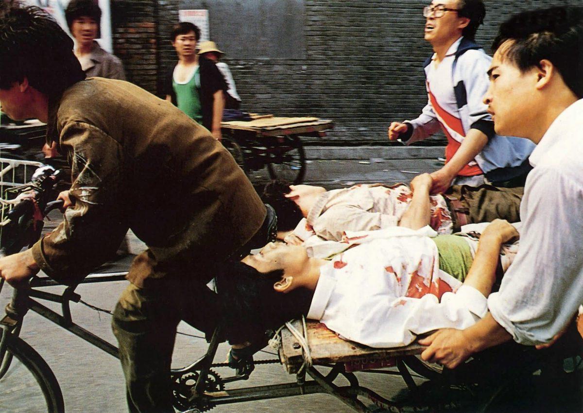 A rickshaw driver peddles wounded people to a nearby hospital in Beijing after they were attacked by Chinese soldiers in Tiananmen Square on June 4, 1989. (Liu Heung Shing/AP Photo)