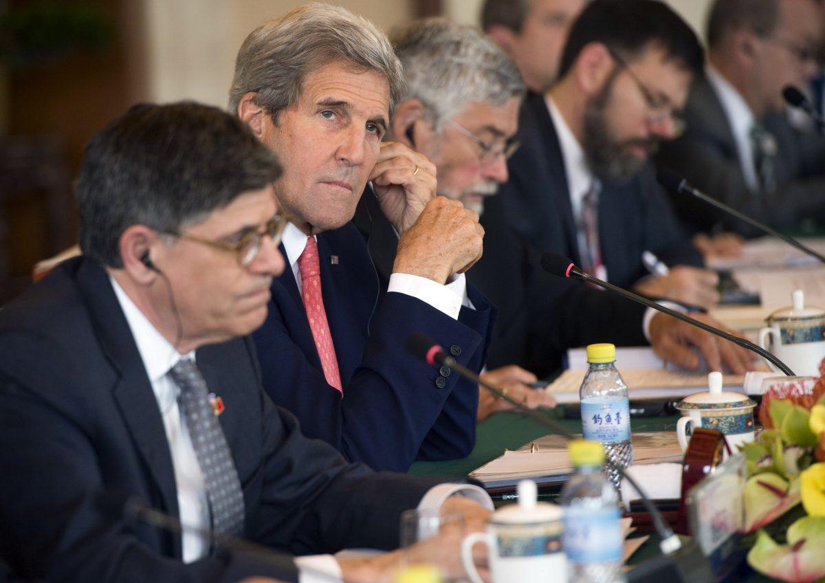 U.S. Secretary of State John Kerry (2L) and U.S. Treasury Secretary Jacob Lew (L) attend a session on Climate Change during the U.S.–China Strategic and Economic Dialogues at Diaoyutai State Guesthouse in Beijing on June 6, 2016. (Saul Loeb/Pool Photo via AP)
