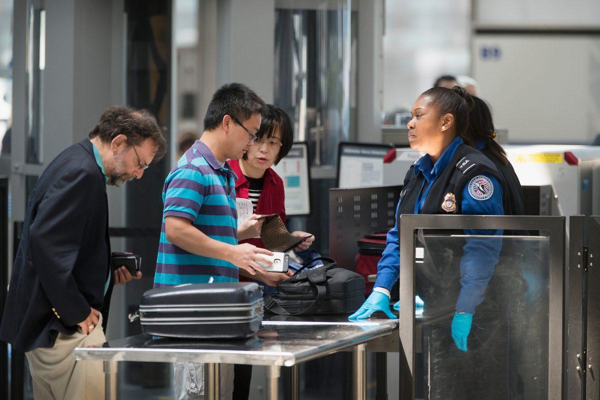 Travelers are screened by TSA workers at a security check point at O'Hare Airport in Chicago on June 2, 2015. (Scott Olson/Getty Images)
