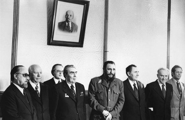 Cuban First Secretary of the Cuban Communist Party and President of the State Council Fidel Castro (4th-R) poses under a portrait of Lenin before his meeting with General Secretary of the CPSU Central Committee Leonid Brezhnev (4th L) in Moscow on April 5, 1977. (STR/AFP/Getty Images)