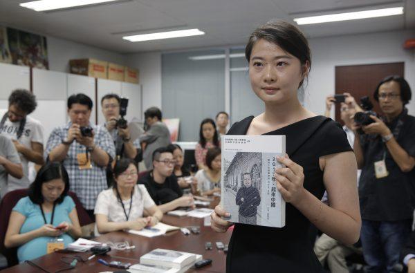 Grace Geng, the daughter of one of China's most prominent human rights lawyers Gao Zhisheng, presents a book authored by her father at a news conference in Hong Kong on June 14, 2016. The book, titled “Stand Up China 2017 - China’s Hope: What I Learned During Five Years as a Political Prisoner” is a memoir by Gao in which he details the torture he says he endured while detained and jailed as well as three years of being held in solitary confinement. (AP Photo/Kin Cheung)