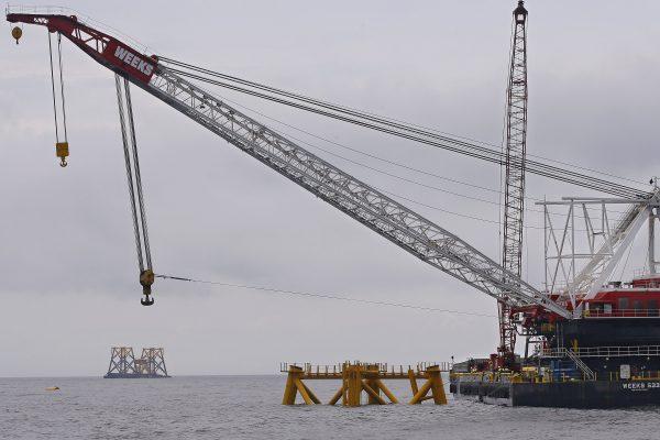 In this July 27, 2015 file photo, a construction crane works over a foundation for a wind turbine installed by Deepwater Wind in the nation's first offshore wind farm construction project off Block Island, R.I. Now another offshore site is under proposal, this time about 11 miles south of Long Island, N.Y. (AP Photo/Stephan Savoia, File)
