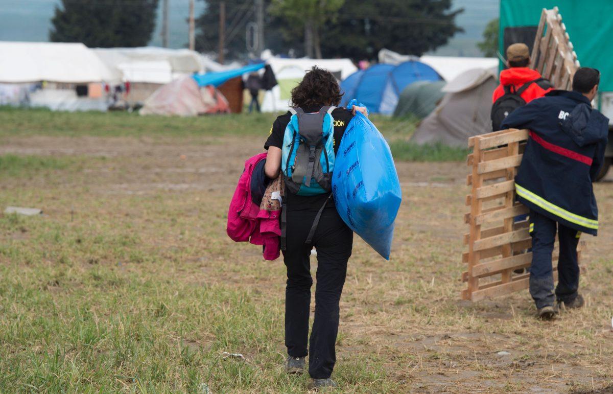 People carry items in a makeshift camp for migrants at the Greek-Macedonian border near the village of Idomeni on May 3, 2016. (Tobia Schwarz/AFP/Getty Images)