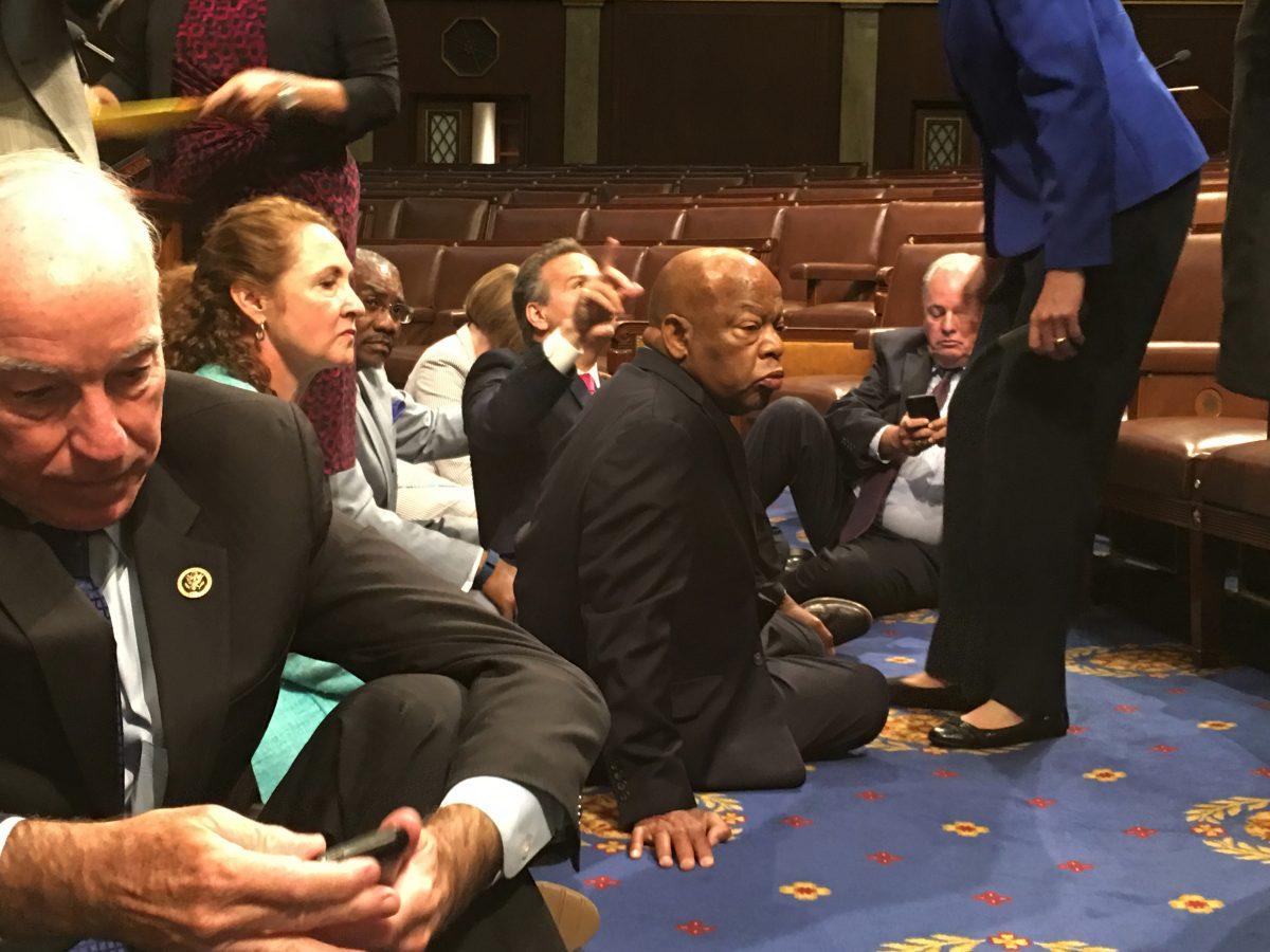 Democrat members of Congress, including Rep. John Lewis (D-Ga.), center, and Rep. Joe Courtney (D-Conn.), left, participating in a sit-down protest seeking a vote on gun control measures on the floor of the House on Capitol Hill in Washington on June 22, 2016. (Rep. John Yarmuth via AP)