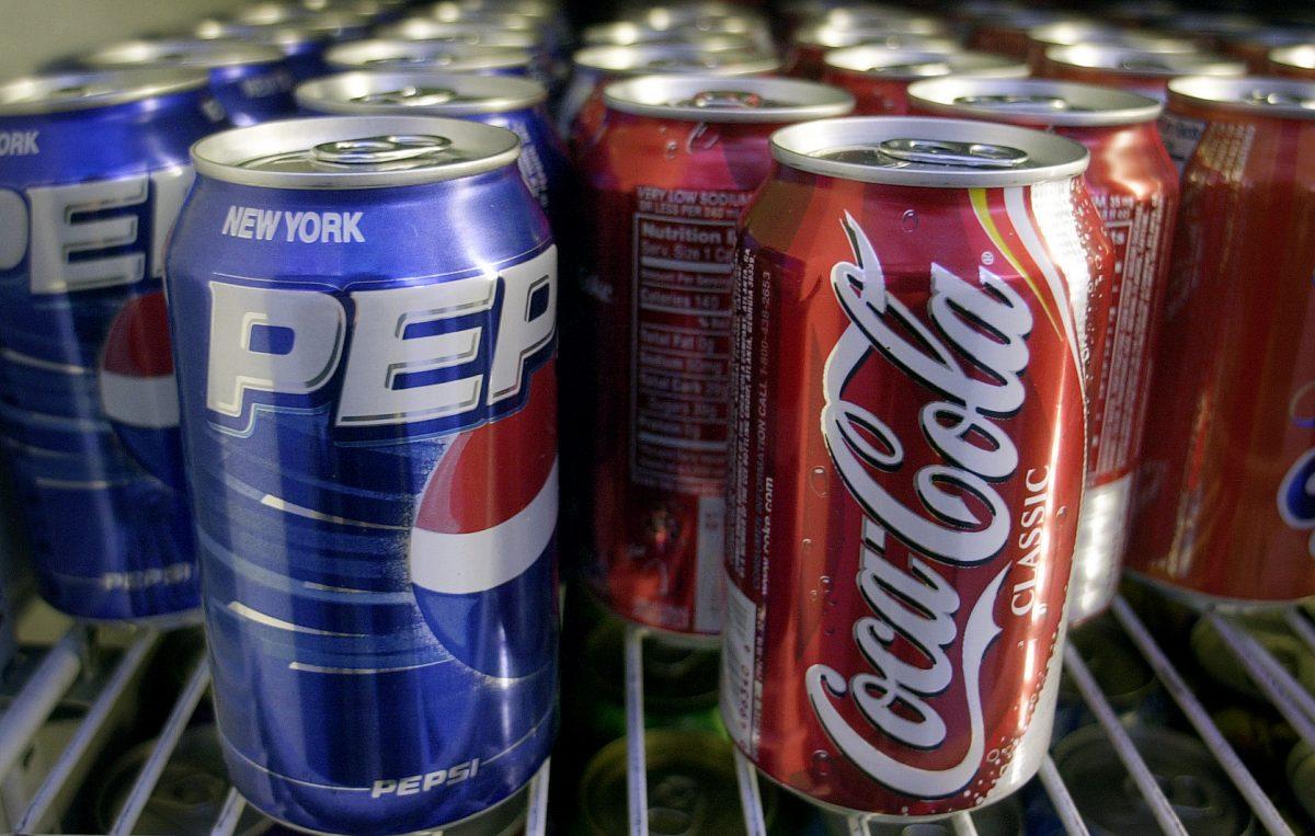 Cans of Pepsi and Coke are shown in a news stand refrigerator display rack in a New York file photo from April 22, 2005. (AP Photo/Mark Lennihan)