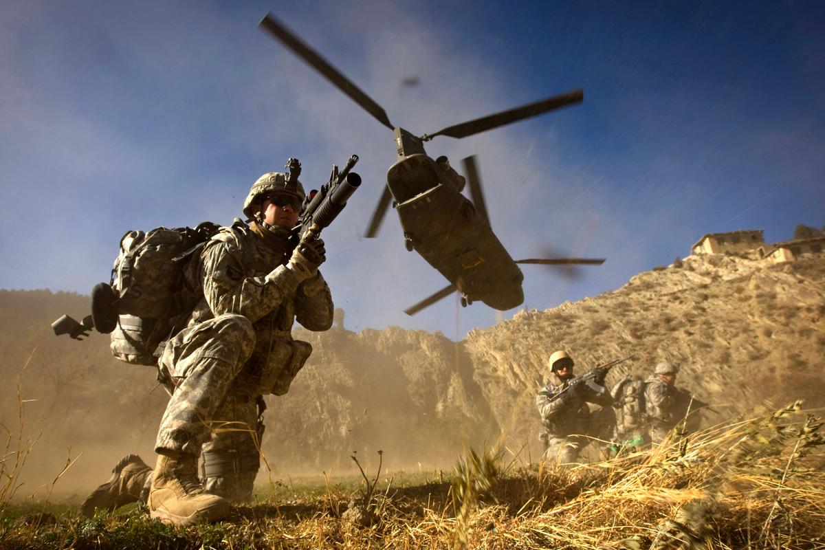  US Army soldiers from 2-506 Infantry 101st Airborne Division and Afghan National Army soldiers take positions after racing off the back of a UH-47 Chinook helicopter during the launch of Operation Shir Pacha into the Derezda Valley in the rugged Spira mountains in Khost province, along the Afghan-Pakistan Border, directly across the border from Pakistan's lawless Waziristan region, on Nov. 20, 2008. (DAVID FURST/AFP/Getty Images)