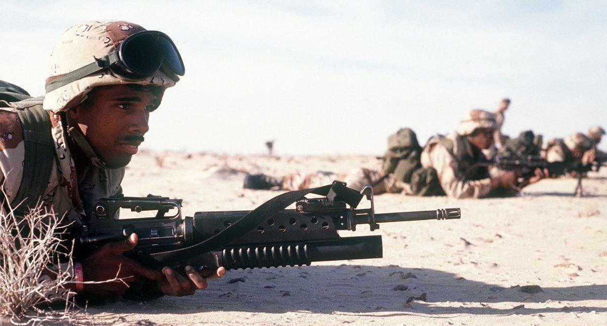 Cpl. Ray Penna guards the camp perimeter with an M-16A2 rifle during an Imminent Thunder training exercise, a part of Operation Desert Shield in 1991. (DOD via Getty Images)