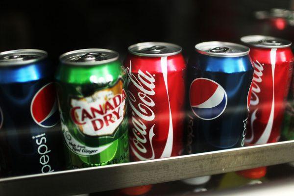 <span class="caption">Soda, specifically cola with its caffeine and phosphoric acid, eats away at teeth and bone.</span>. (Spencer Platt/Getty Images)