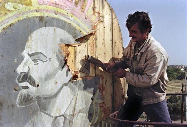 A resident of Baku, in the southern Soviet republic of Azerbaijan, uses an axe to hack apart a placard showing a portrait of Russian Bolshevik revolutionary leader Vladimir Lenin, on Sept. 21, 1991. (Anatoly Sapronenkov/AFP/Getty Images)