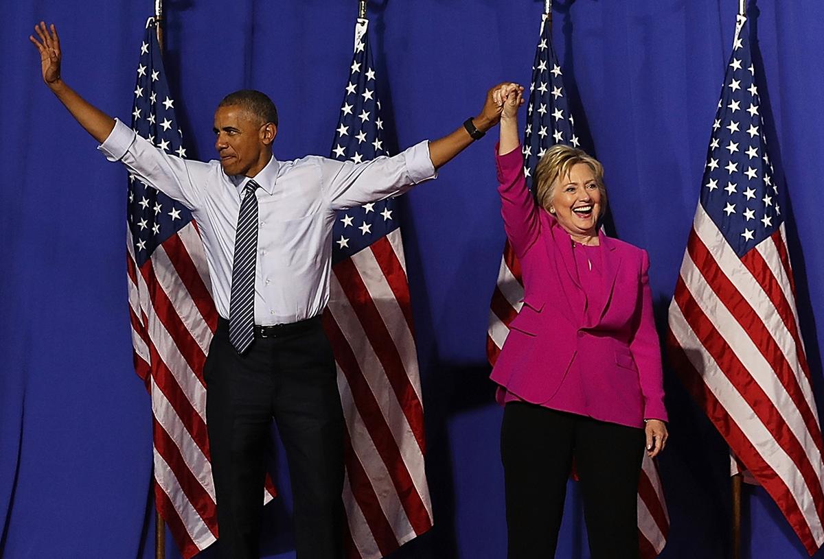 Democratic presidential candidate former Secretary of State Hillary Clinton (R) and President Barack Obama greet supporters during a campaign rally in Charlotte, North Carolina, on July 5, 2016. (Justin Sullivan/Getty Images)