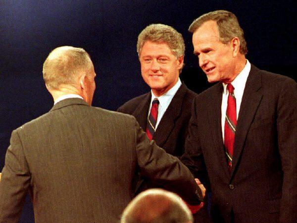 U.S. President George Bush (R) and presidential candidates Ross Perot (L) and Bill Clinton (C) greet each other at the athletic center at Washington University in St. Louis, Mo., on Oct. 11, 1992. The men are participating in the first of three U.S. presidential debates. (DAVID AKE/AFP/Getty Images)