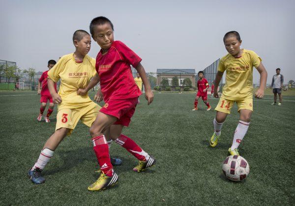 Children play soccer on a practice pitch at the Evergrande International Football School in Guangdong Province, China. (Kevin Frayer/Getty Images)