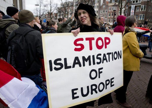 A woman holds a placard during a Pegida demonstration against immigration and Islamisation in Amsterdam, Netherlands, on Feb. 6, 2016. (Peter Dejong/AP Photo)