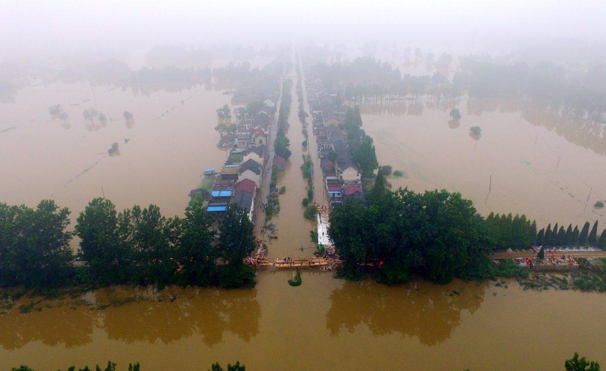  This overhead view shows trees and houses submerged by floodwaters after the heavy rainfall hit a dam along the Xiangyang River in Xinji Village in Yangzhou in east China's Jiangsu province on July 6, 2016. (STR/AFP/Getty Images)