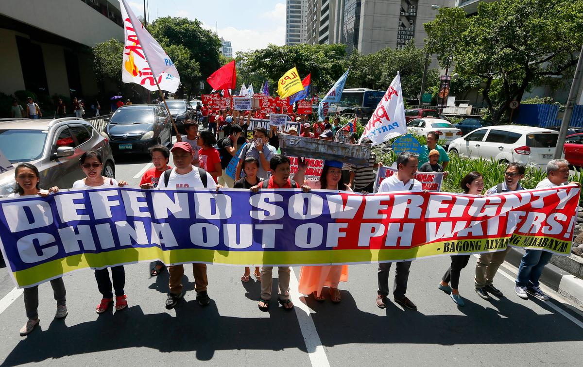 Protesters shout slogans as they march outside of the Chinese Consulate hours before the Hague-based UN international arbitration tribunal is to announce its ruling on South China Sea, in Makati city east of Manila, Philippines on July 12, 2016. The protesters are urging China to respect the Philippines' rights over its exclusive economic zone and extended continental shelf as mandated by the UN Convention of the Law of the Sea or UNCLOS. (Bullit Marquez/AP)