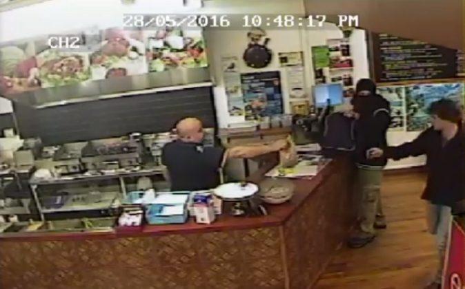 Video: Store Owner Ignores Armed Robber, Serves His Customer Instead
