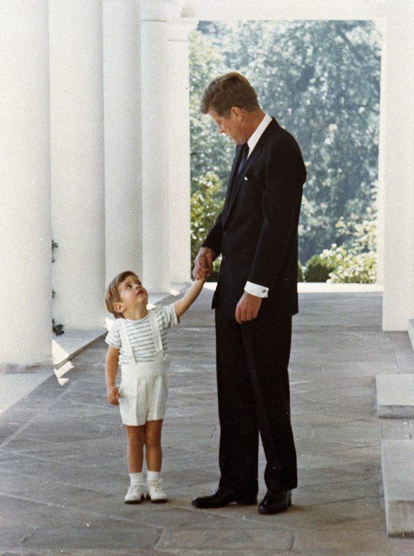 U.S. President John F. Kennedy holds hands with his son, John F. Kennedy Jr., outside the White House in Washington in 1963. (AP Photo, File)
