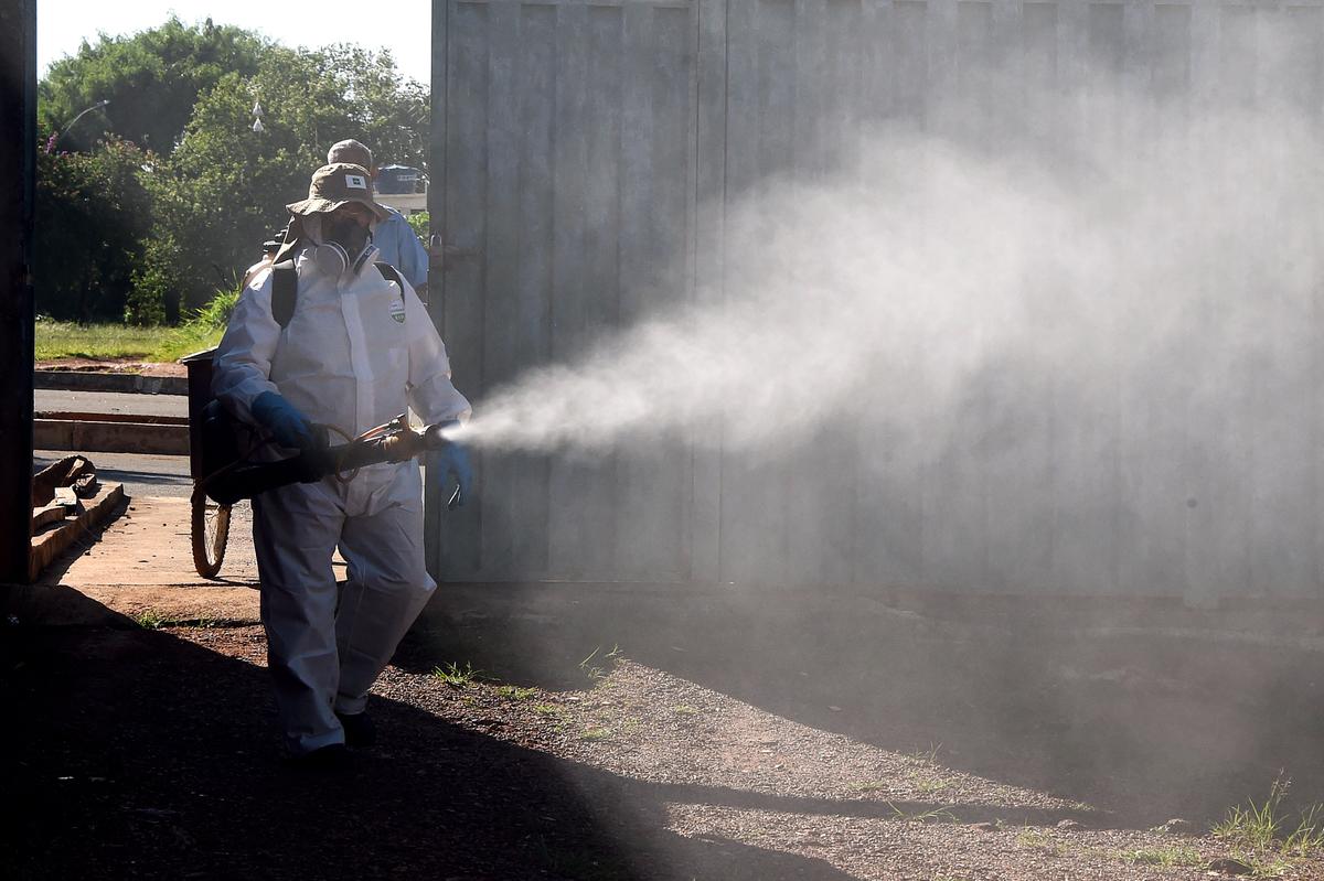 An employee of Brazil's National Health Foundation fumigates against the Aedes aegypti mosquito, vector of the Dengue, Chikungunya fever, and Zika viruses, in Gama, 28 miles south of Brasilia, on Feb. 17, 2016. (Evaristo Sa/AFP/Getty Images)