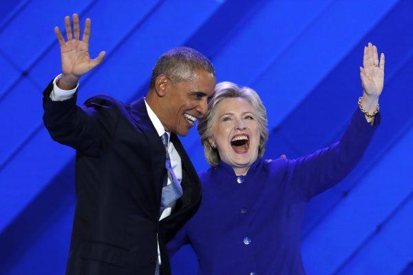 President Barack Obama and Democratic Presidential nominee Hillary Clinton wave to delegates after President Obama's speech during the third day of the Democratic National Convention in Philadelphia, on July 27, 2016. (J. Scott Applewhite/AP Photo)