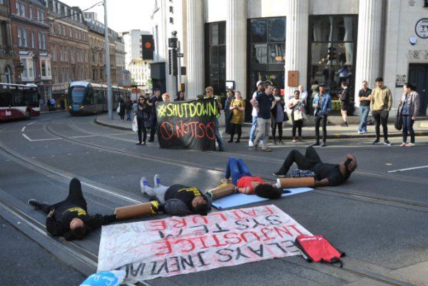 Activists lay on the road outside Nottingham Theatre Royal to protest for the social justice movement Black Lives Matter in Nottingham, England on Aug. 5, 2016. (Edward Smith/PA via AP)