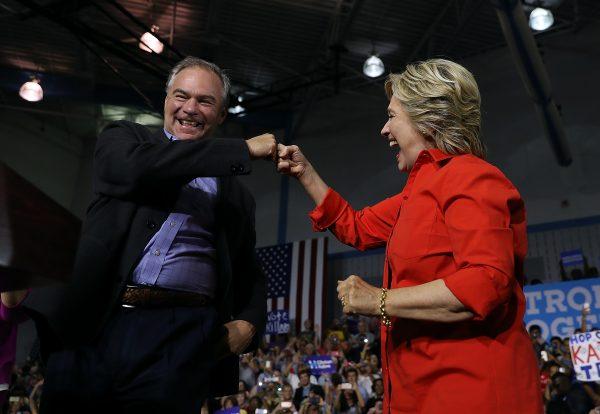 2016 Democratic presidential nominee and former Secretary of State Hillary Clinton, and Democratic vice presidential nominee U.S. Sen Tim Kaine (D-VA) fist bump during a campaign rally at East High School in Youngstown, Pennsylvania on July 30, 2016. (Justin Sullivan/Getty Images)
