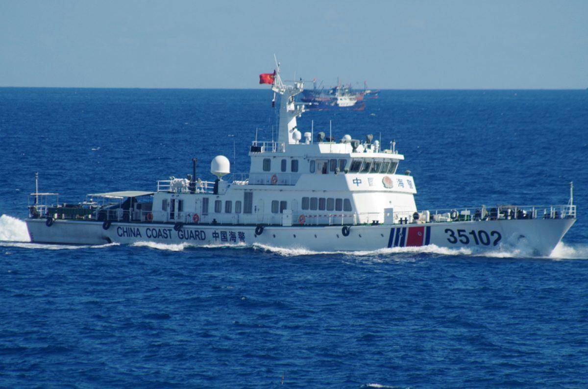 A Chinese coast guard cutter in the East China Sea lurks behind a flotilla of 230 Chinese fishing boats that swarmed the Japanese-controlled, Chinese-claimed Senkaku Islands in August 2016. (11th Regional Coast Guard Headquarters via AP)