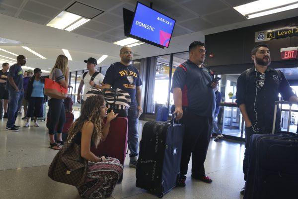 Delta passengers wait in line at a ticket counter at Newark Liberty International Airport in Newark, N.J., on Aug. 8, 2016. (Seth Wenig/FILE PHOTO via AP)