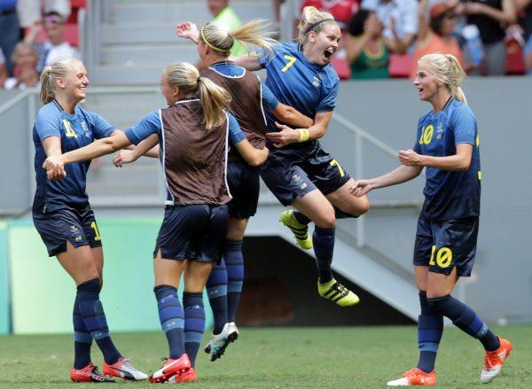 Sweden players celebrate after Stina Blackstenius (L) scored her team's first goal during a quarter-final match of the women's Olympic football tournament between the United States and Sweden in Brasilia, Brazil, on Aug. 12, 2016. (Eraldo Peres/AP Photo)