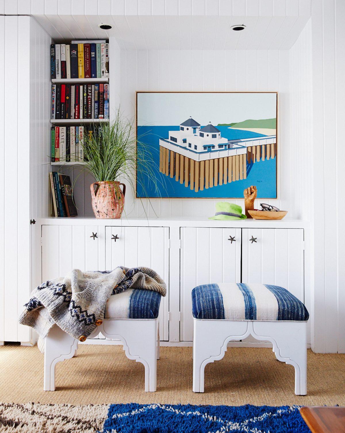 A living room showcasing closed cabinets with starfish-shaped handles is a great space for hiding bins filled with toys. (Victoria Pearson/Nathan Turner via AP)