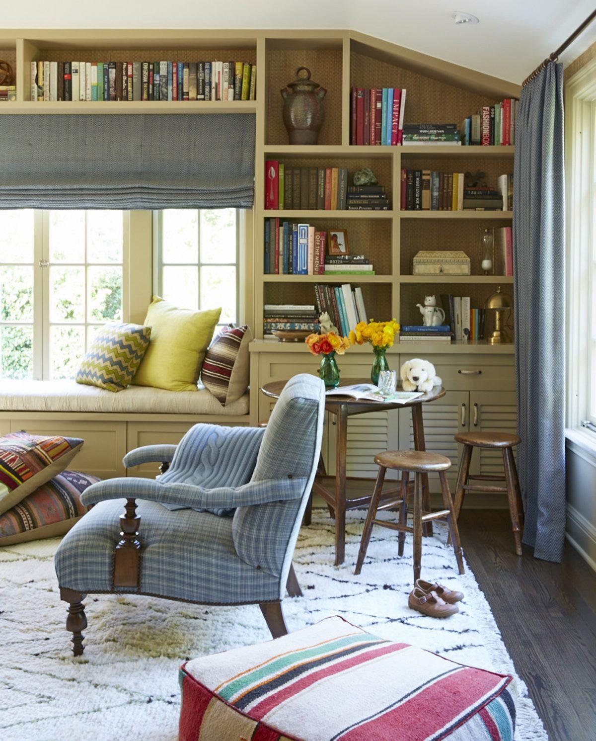 A child-friendly family room provides closed storage for stashing toys and a low-slung table with stools small enough for a child but stylish enough to please the grown-ups. (Victoria Pearson/Nathan Turner via AP)