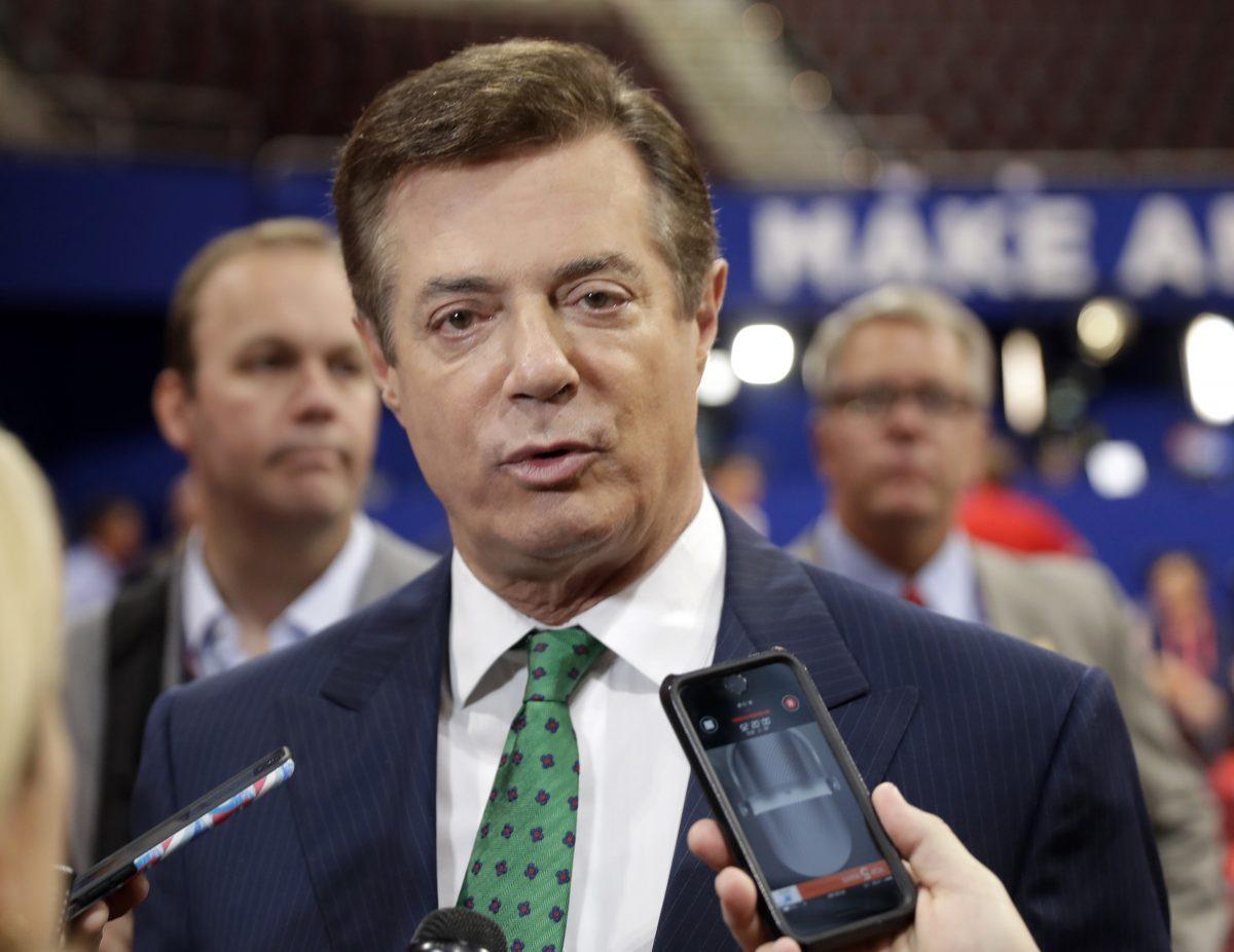 Paul Manafort talks to reporters on the floor of the Republican National Convention at Quicken Loans Arena in Cleveland on July 17, 2016. (Matt Rourke/AP Photo)