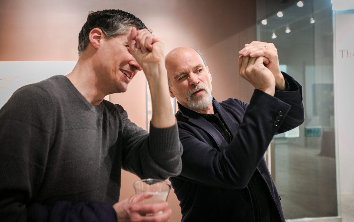 Founder of The Florence Academy of Art Daniel Graves (R) talks about a painting with artist Edward Minoff at the opening of the "Consecrated Reality" art exhibit, in the gallery of The Florence Academy of Art-U.S. branch, on May 1, 2016. (Milene Fernandez/Epoch Times)