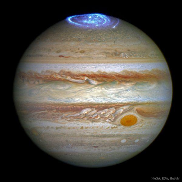 Jupiter has aurorae. Like Earth, the magnetic field of the gas giant funnels charged particles released from the sun onto the poles. As these particles strike the atmosphere, electrons are temporarily knocked away from existing gas molecules. Electric force attracts these electrons back. As the electrons recombine to remake neutral molecules, auroral light is emitted. (NASA, ESA, Hubble)
