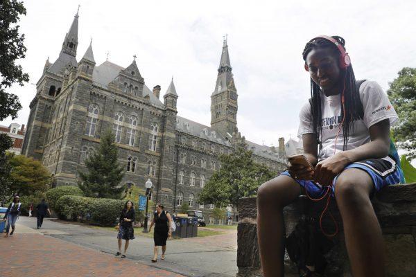 Deja Lindsey, 20, a junior at Georgetown University, talks on her cell phone in front of Healy Hall on campus in Washington on Sept. 1, 2016. Georgetown University will give preference in admissions to the descendants of slaves owned by the Maryland Jesuits as part of its effort to atone for profiting from the sale of enslaved people. (AP Photo/Jacquelyn Martin)