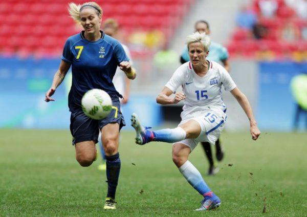 In this Friday, Aug. 12, 2016, file photo, United States' Megan Rapinoe, right, kicks the ball past Sweden's Lisa Dahlkvist. (AP Photo/Eraldo Peres, File)