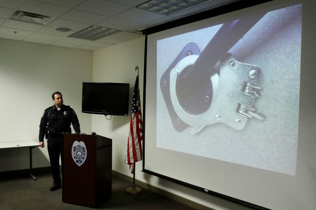 Police Video Shows Slaying Suspect Breaking Cuffs, Escaping