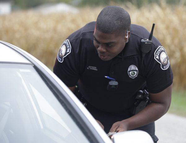 An officer carries out a traffic stop, in Whitestown, Indiana., on Sept. 29, 2015. (AP Photo/Darron Cummings)