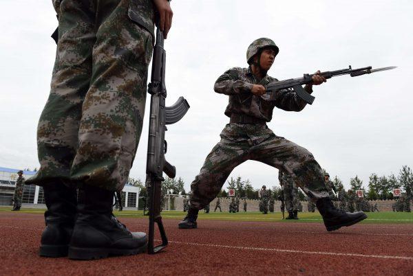 Chinese People's Liberation Army cadets conduct bayonet drills at the PLA's Armoured Forces Engineering Academy in Beijing on July 22, 2014. (Greg Baker/AFP/Getty Images)